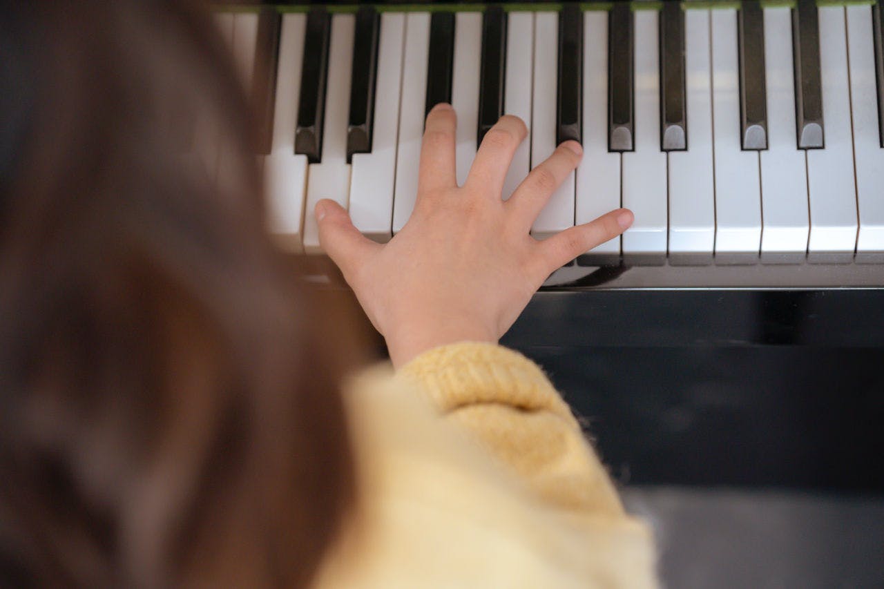 A Hand Playing a Piano at a Piano Lesson